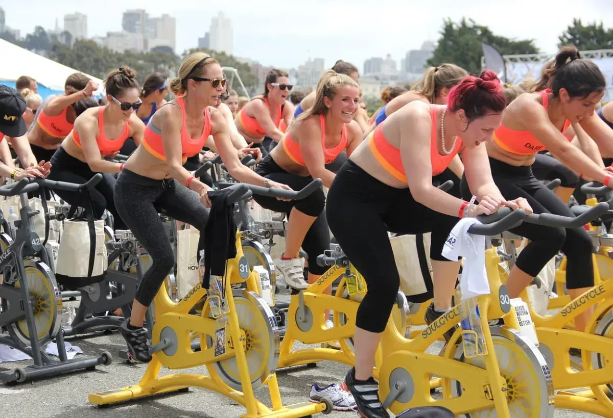 women on stationery bikes