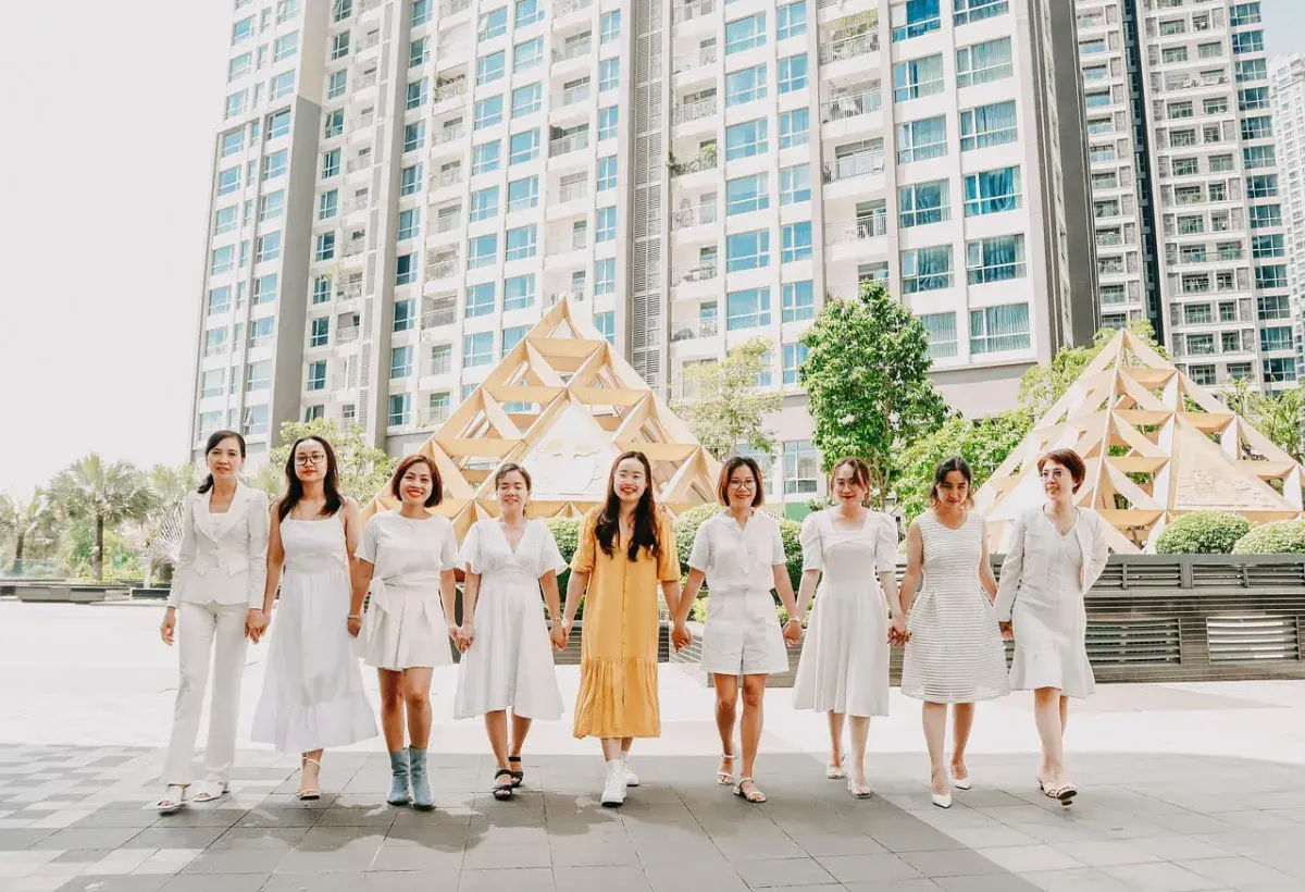 women holding hand in white clothing