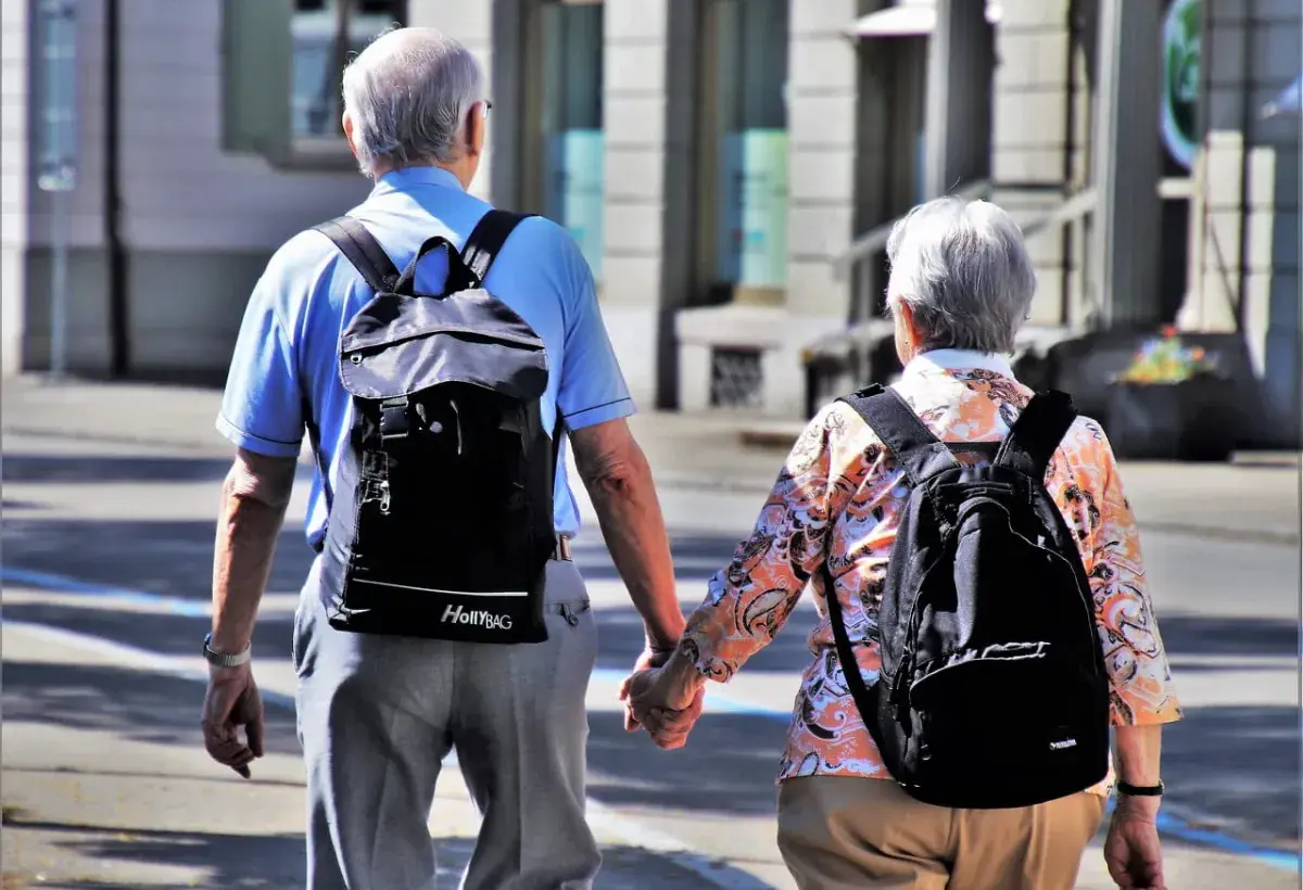 seniors holding hands walking 