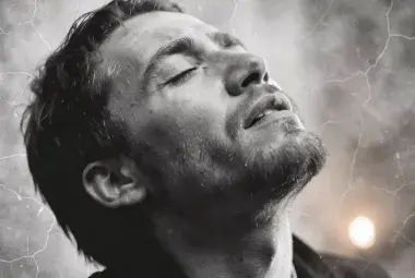 A close-up of a person's face in an emotional moment, symbolizing the raw vulnerability and inner struggle in Linkin Park's "Crawling."