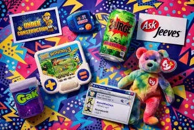 A colorful flat lay of iconic 1990s items, including a Hit Clips player, Beanie Baby, and Surge soda, capturing the decade's nostalgic spirit.