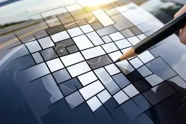 A crossword puzzle grid overlaid on a car hood with an open road background, symbolizing the ultimate challenge for automotive enthusiasts.