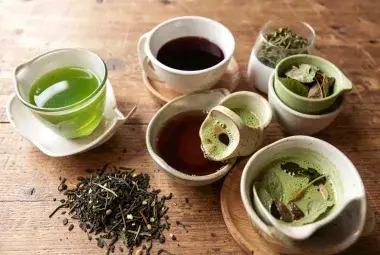 Assorted tea varieties including green tea black tea matcha and herbal tea in cups