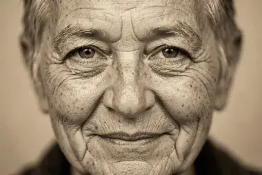 Intimate black and white portrait of an older person's face, focusing on expressive eyes and natural wrinkles, conveying wisdom, dignity, and the strength of aging
