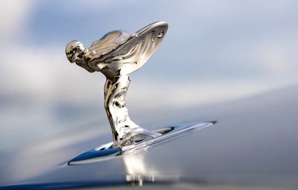 Which British luxury car is famous for its “Spirit of Ecstasy” hood ornament?